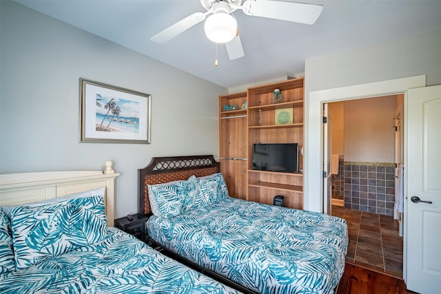 bedroom with dark wood-type flooring, tile walls, and ceiling fan