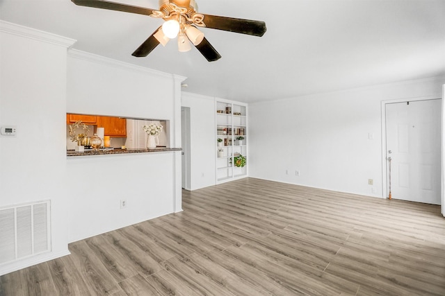 unfurnished living room with ornamental molding, ceiling fan, and light wood-type flooring