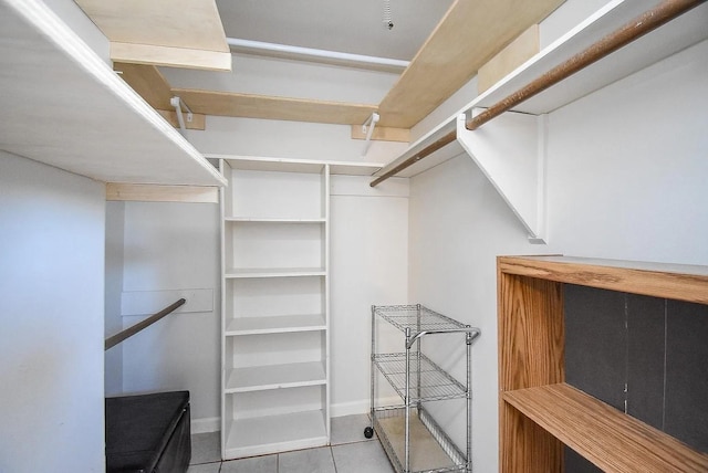 walk in closet with light tile patterned floors