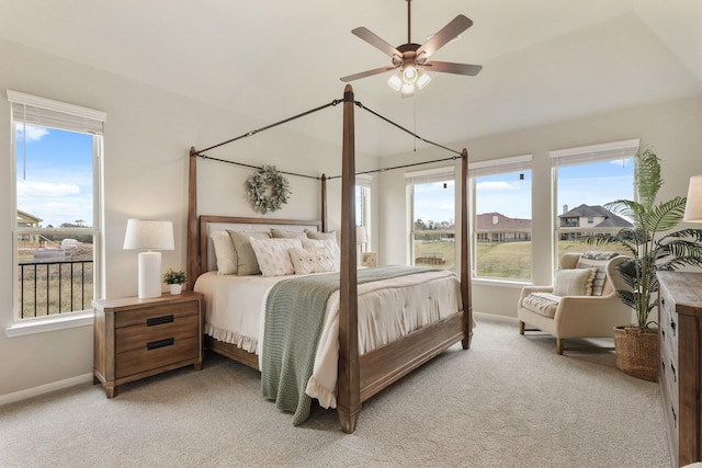 bedroom featuring multiple windows, light carpet, and ceiling fan