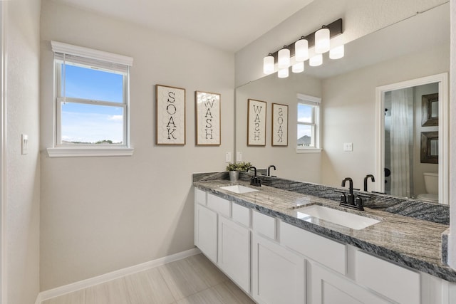 bathroom featuring vanity and toilet