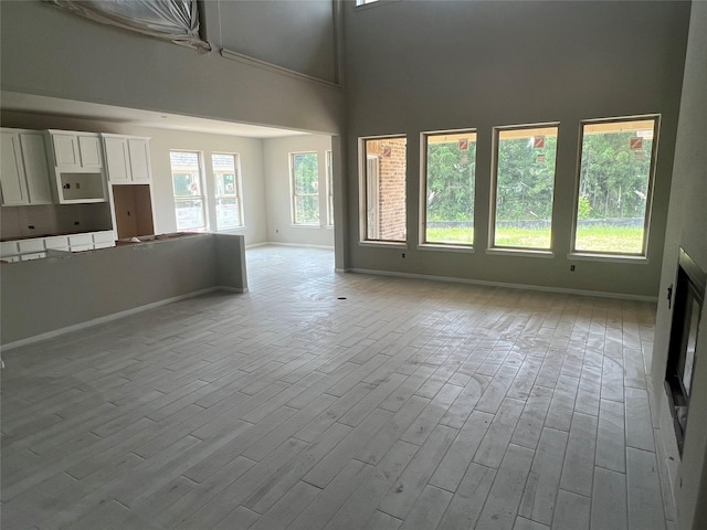 286 Peninsula Point Dr, Montgomery, TX 77356 - unfurnished living room featuring wood finished floors and a high ceiling