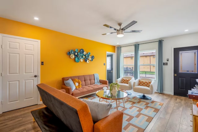 living room with hardwood / wood-style flooring and ceiling fan