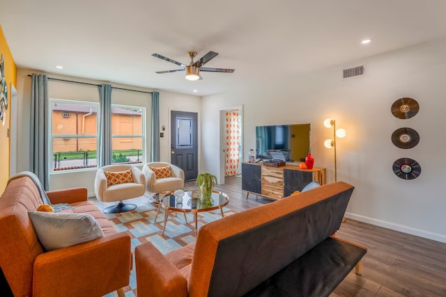 living room featuring hardwood / wood-style flooring and ceiling fan