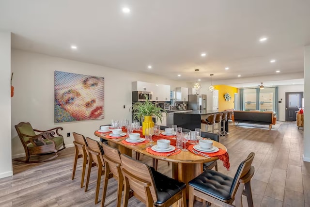 dining room featuring light hardwood / wood-style floors and ceiling fan