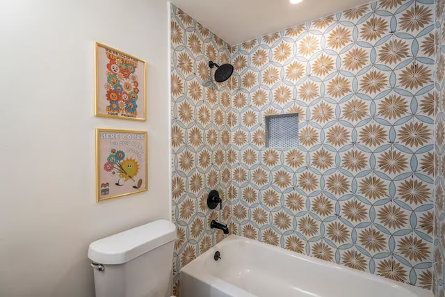 bathroom with tiled shower / bath combo and toilet