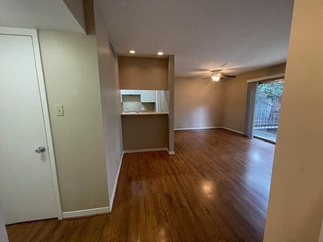 interior space with recessed lighting, visible vents, a ceiling fan, wood finished floors, and baseboards