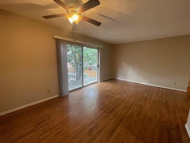 unfurnished room featuring dark wood-type flooring and ceiling fan