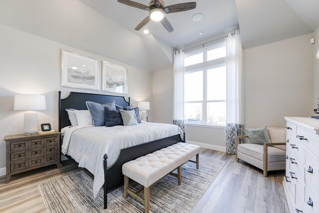 bedroom with lofted ceiling, a ceiling fan, light wood finished floors, and baseboards