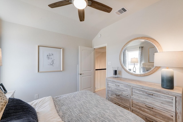 bedroom with vaulted ceiling, visible vents, and ceiling fan