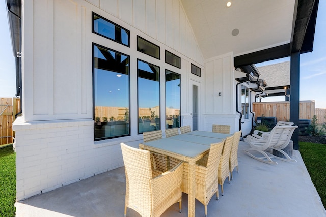 view of patio featuring outdoor dining space and fence