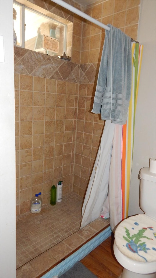 bathroom with toilet and curtained shower