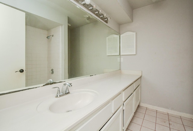 bathroom featuring vanity, tile patterned floors, and tiled shower