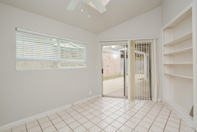 spare room with light tile patterned flooring, ceiling fan, and vaulted ceiling