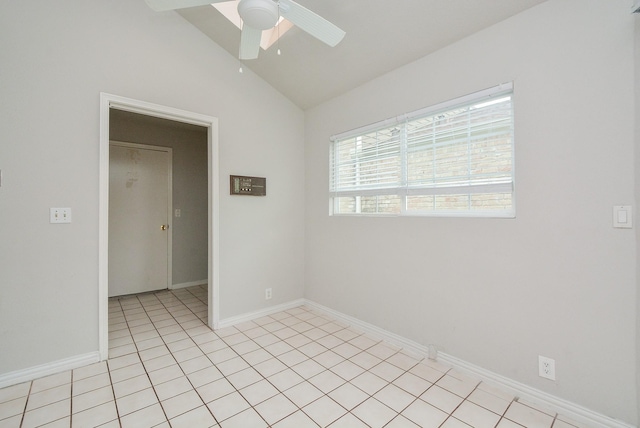 tiled empty room featuring lofted ceiling and ceiling fan