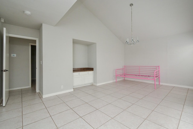 unfurnished room featuring light tile patterned flooring, high vaulted ceiling, and a chandelier