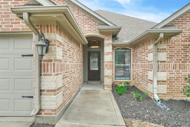 view of exterior entry with a garage