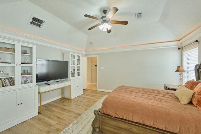 bedroom with a raised ceiling, lofted ceiling, ceiling fan, and light hardwood / wood-style flooring