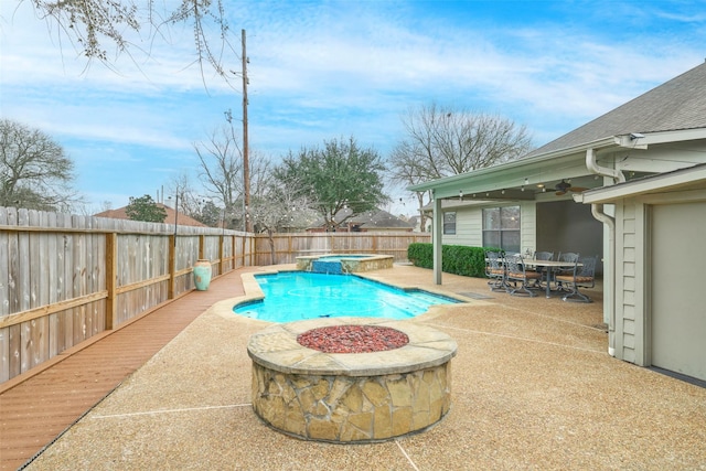 view of pool with a fire pit, a patio area, ceiling fan, and an in ground hot tub