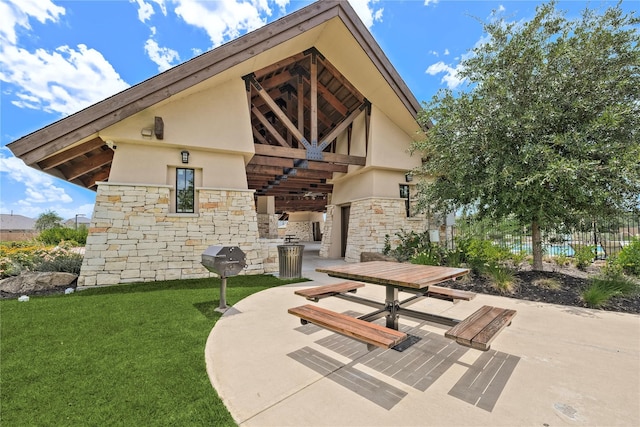 back of house with a yard and a patio area