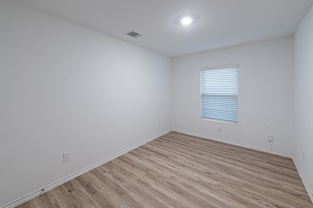 unfurnished room featuring light hardwood / wood-style floors