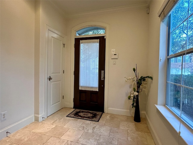 entryway featuring crown molding and plenty of natural light