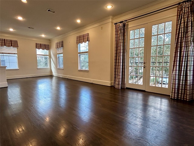 empty room featuring dark hardwood / wood-style flooring, crown molding, and french doors