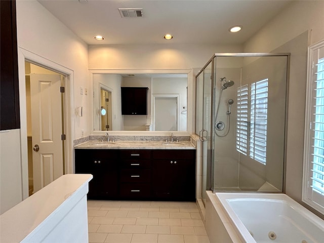 bathroom featuring independent shower and bath, vanity, and tile patterned flooring