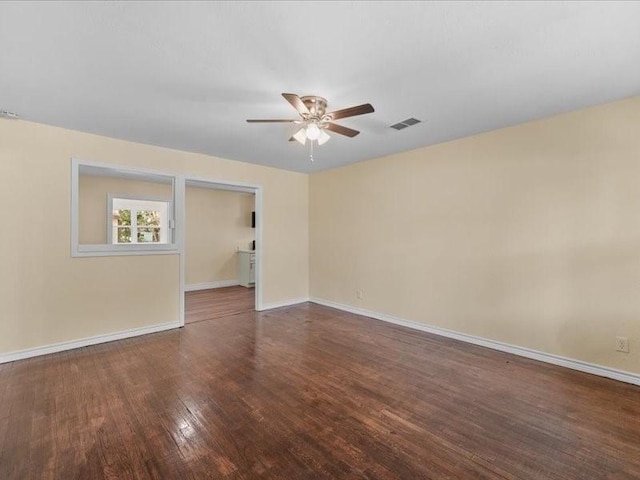 empty room with dark wood-type flooring and ceiling fan