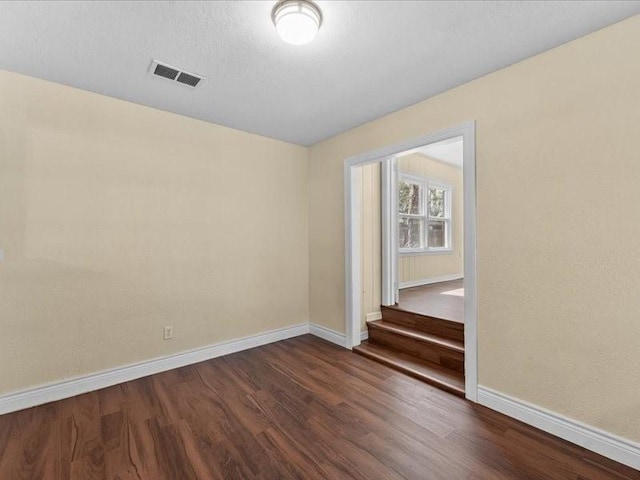 empty room featuring dark wood-type flooring