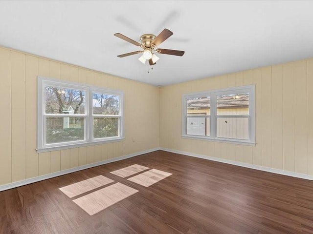 spare room featuring ceiling fan and dark hardwood / wood-style flooring