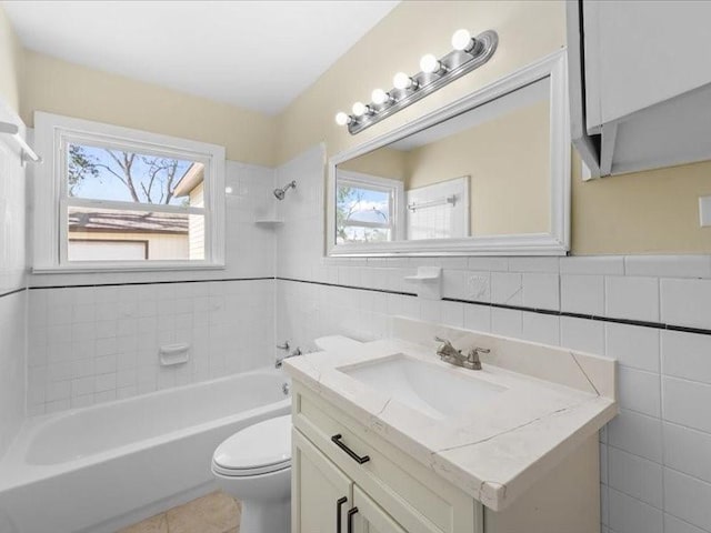 full bathroom featuring tile walls, toilet, and a healthy amount of sunlight