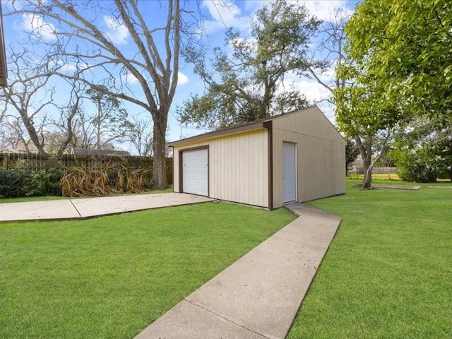 view of outbuilding with a garage and a lawn