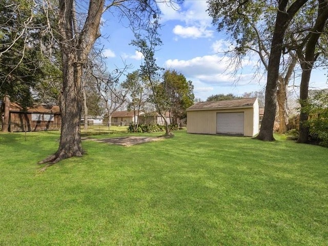 view of yard with a garage and an outdoor structure