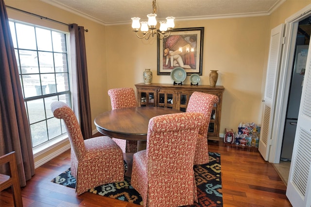 dining area with an inviting chandelier, hardwood / wood-style flooring, crown molding, and a textured ceiling