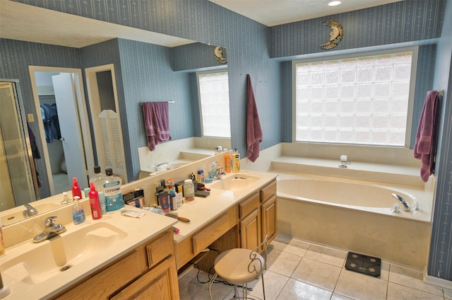 bathroom featuring vanity, a bath, and tile patterned floors