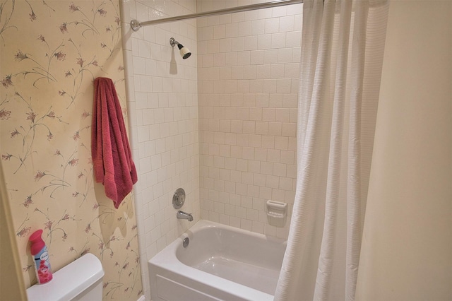 bathroom with toilet and shower / bath combo with shower curtain