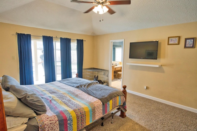 bedroom with vaulted ceiling, carpet flooring, ceiling fan, and a textured ceiling