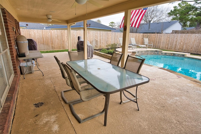 view of patio featuring a fenced in pool and ceiling fan