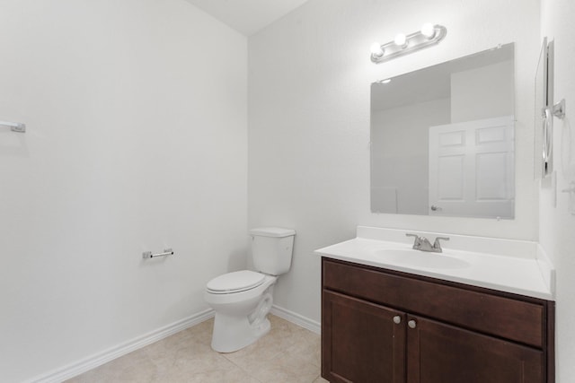 bathroom featuring vanity, tile patterned floors, and toilet