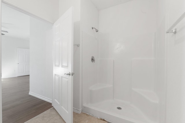 bathroom with wood-type flooring and walk in shower