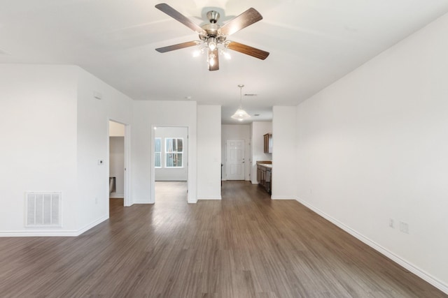 unfurnished living room with dark hardwood / wood-style floors and ceiling fan