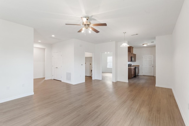 unfurnished living room with light hardwood / wood-style flooring and ceiling fan