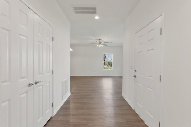 corridor with dark hardwood / wood-style floors