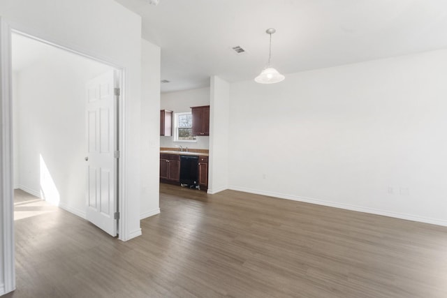 spare room featuring sink and dark wood-type flooring