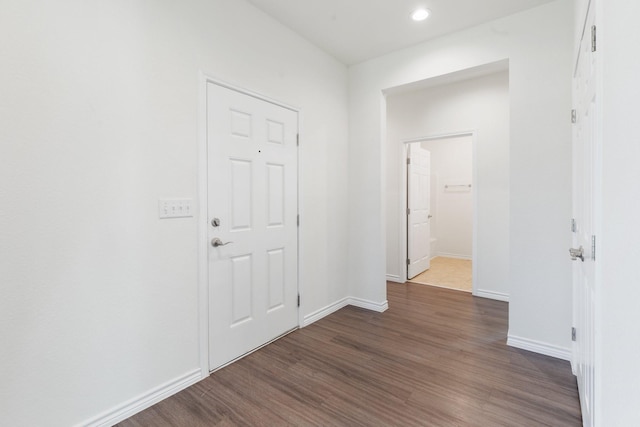 hallway with dark hardwood / wood-style floors