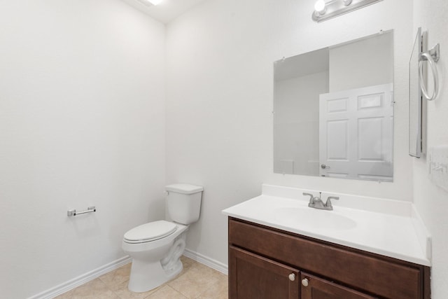 bathroom featuring vanity, tile patterned flooring, and toilet