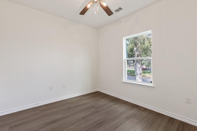 unfurnished room with dark wood-type flooring and ceiling fan