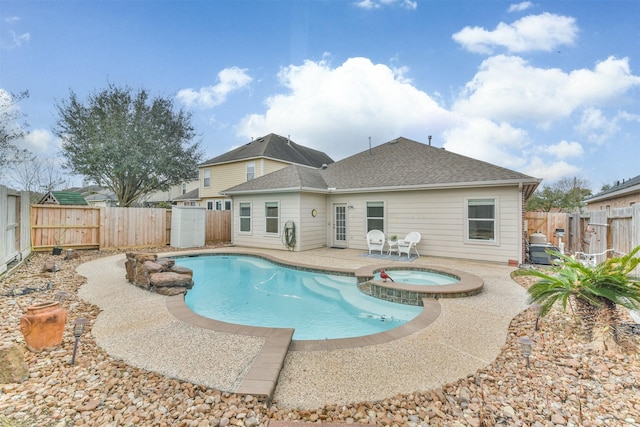 view of swimming pool featuring an in ground hot tub and a patio area