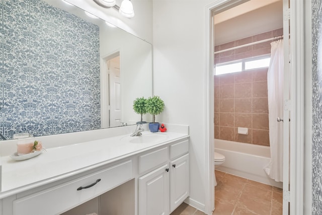 full bathroom featuring tile patterned floors, toilet, vanity, and shower / bath combination with curtain